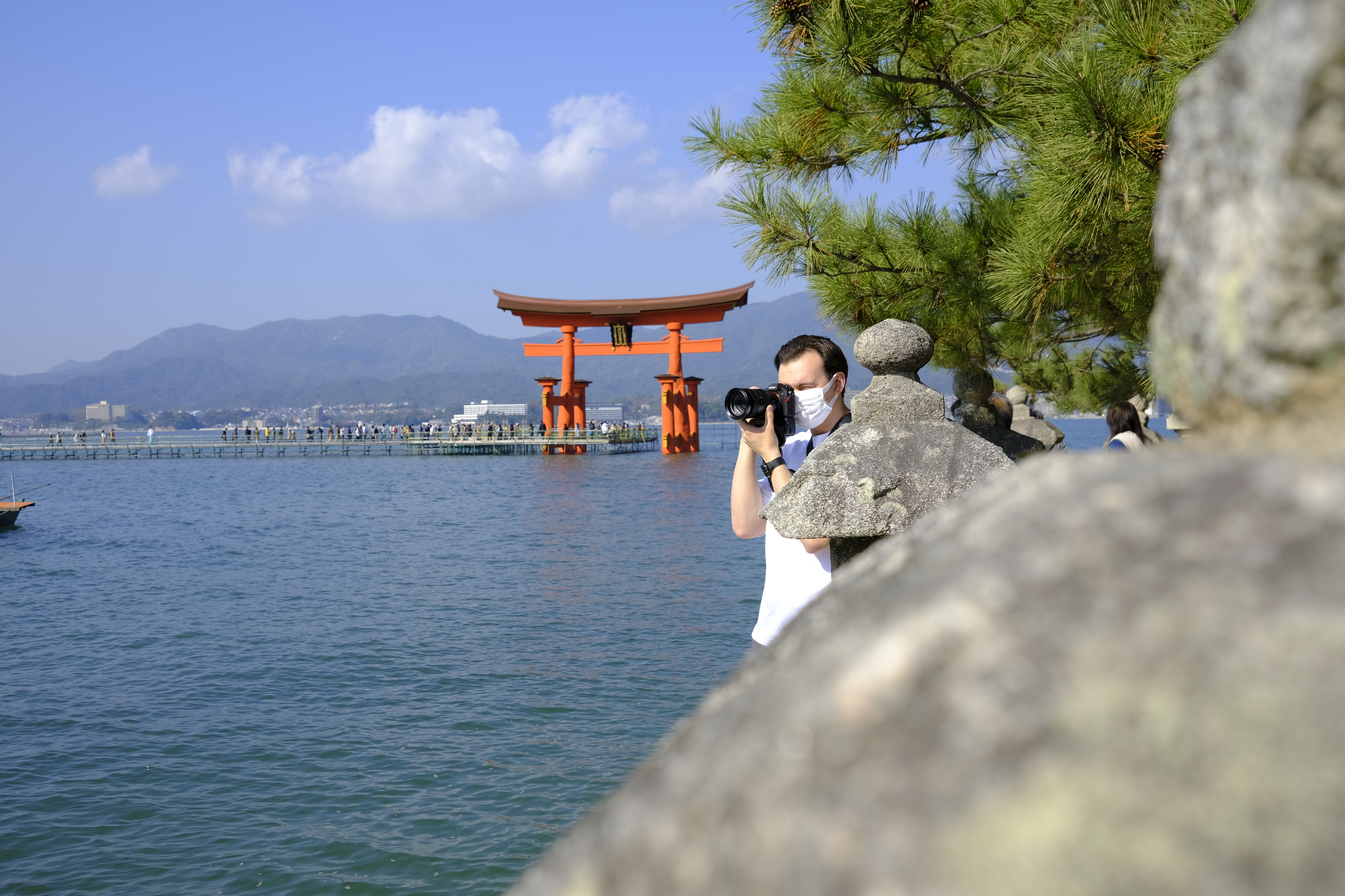 Taking a photo of a friend in front of the Itsukushima Shrine Torii Gate who is taking a photo of Itsukushima Shrine lol